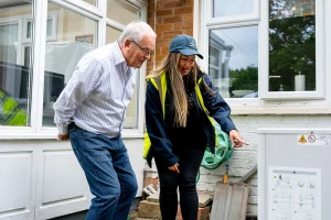 Image of a member of Dodd Group conversing with an elderly gentleman